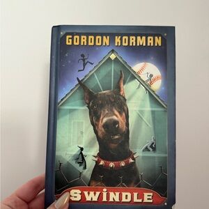 Scholastic Blue and Red 'Swindle' Book by Gordon Korman
